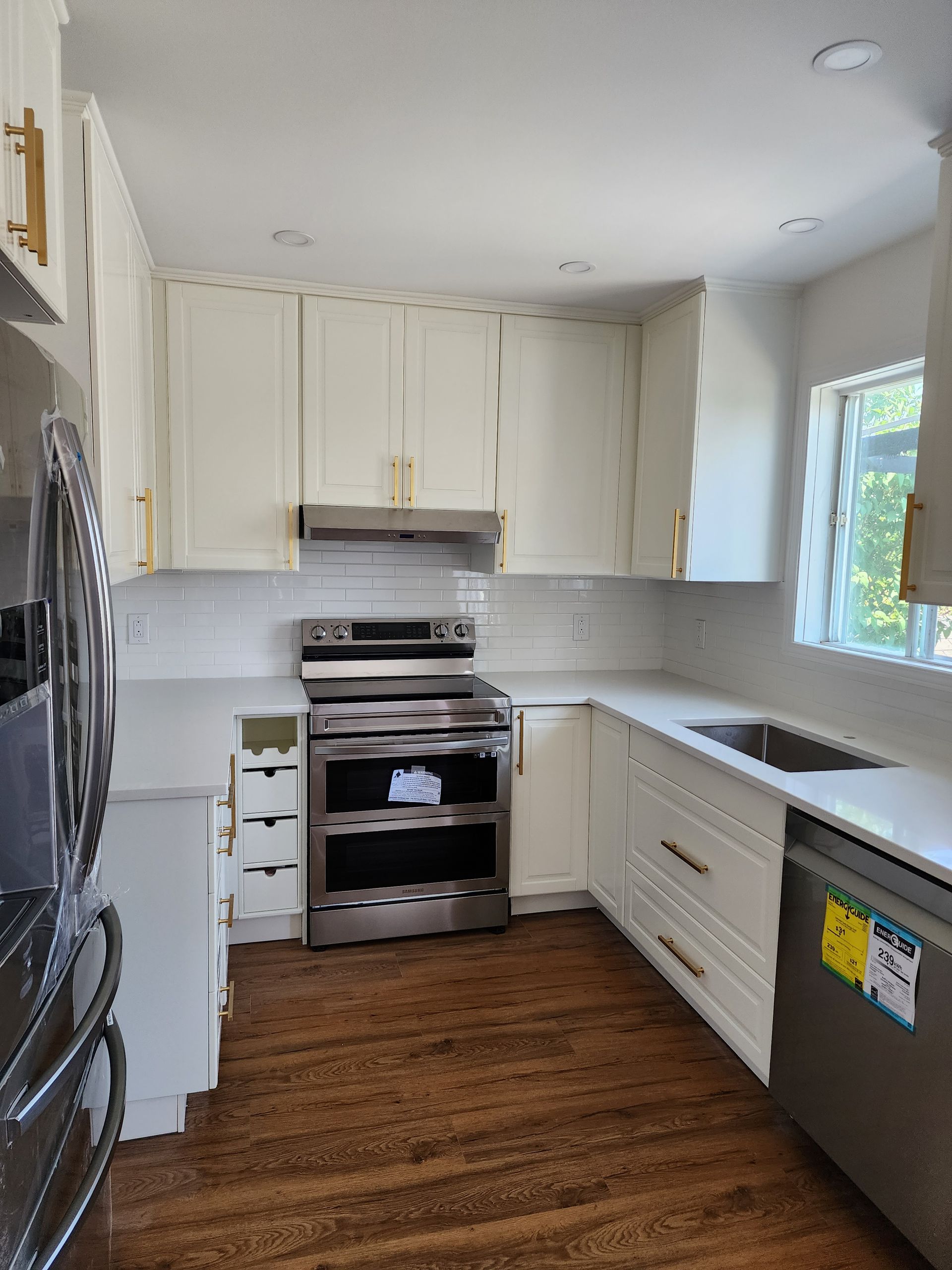 A kitchen with white cabinets and stainless steel appliances.