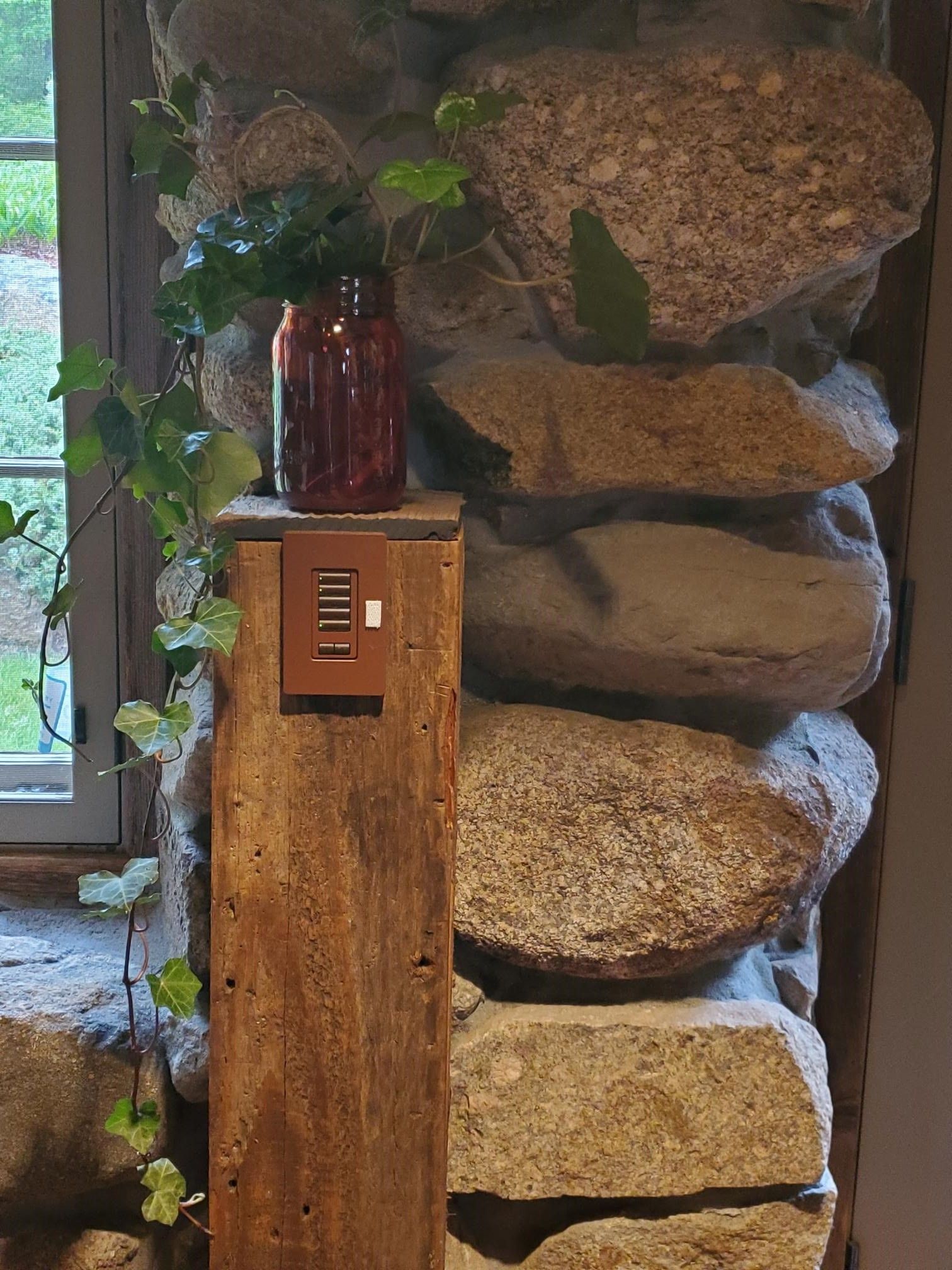 A wall made of rocks and a switch.