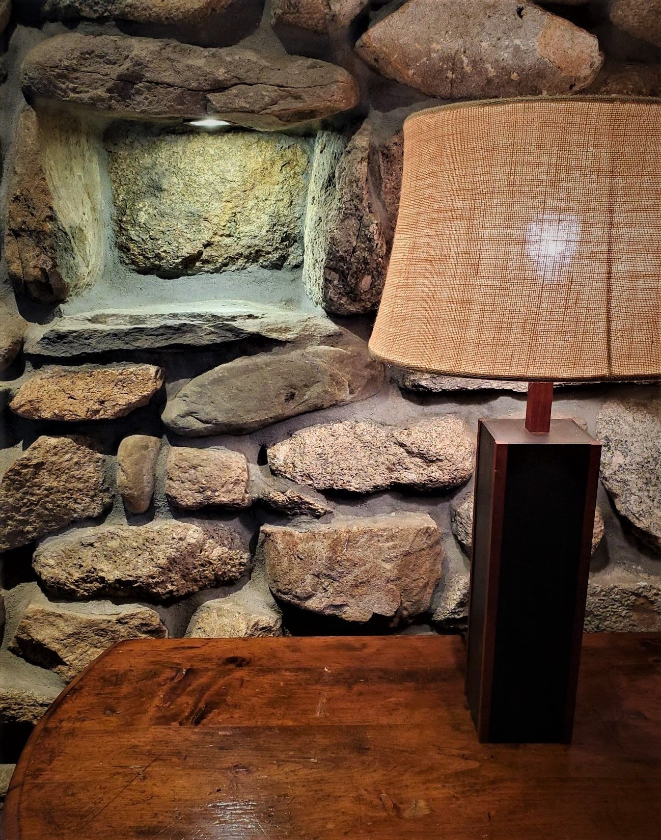 Wall made from rocks and a lamp.