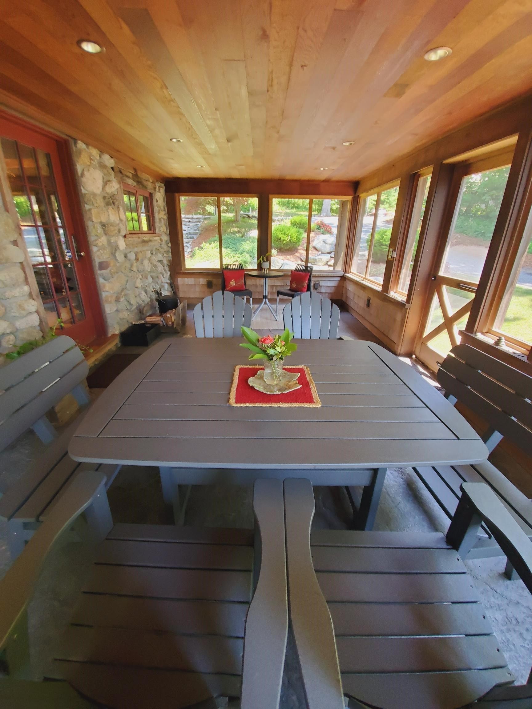 A different angle of clean dining table with chairs.