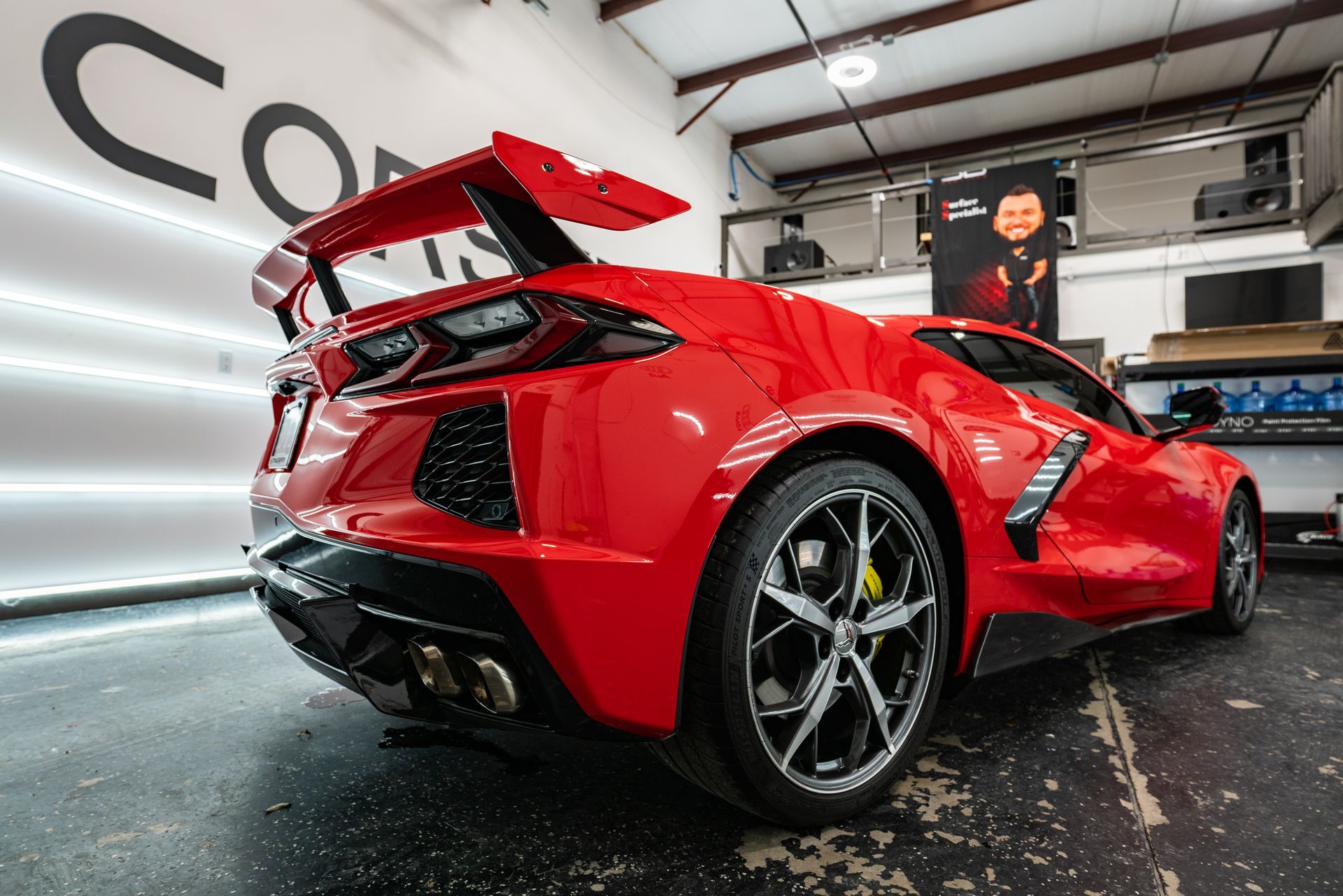 A red sports car is parked in a garage.