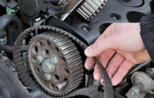 A person is fixing a belt on a car engine | A2Z AutosLLC