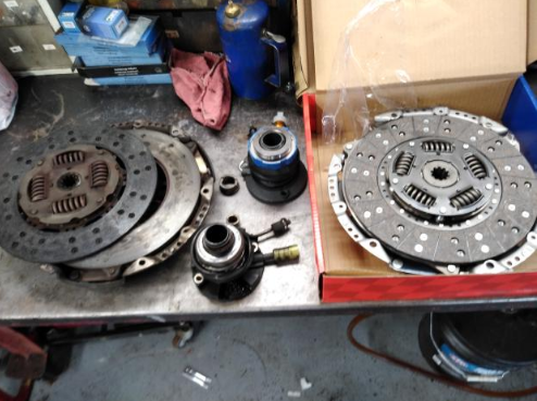Two clutches are sitting on a table next to a box. | A2Z AutosLLC