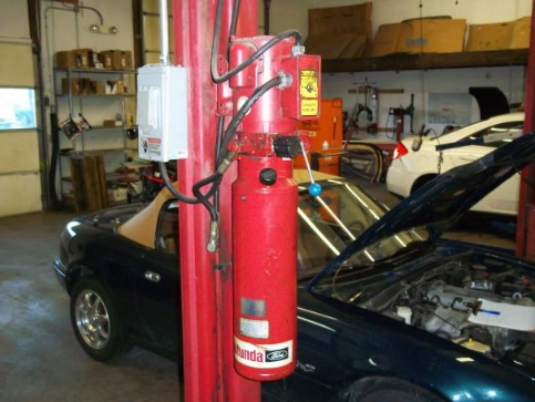 A car with the hood open is sitting in a garage | A2Z AutosLLC