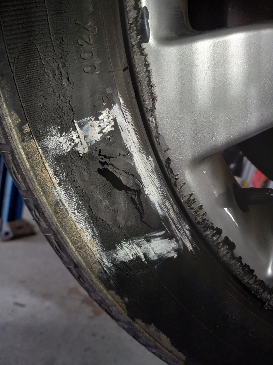 A close up of a damaged tire on a car wheel | A2Z AutosLLC