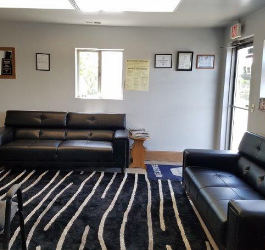 A living room with a black couch | A2z AutosLLC