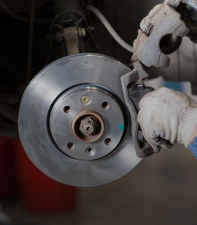 A person is fixing a brake disc on a car | A2z AutosLLC