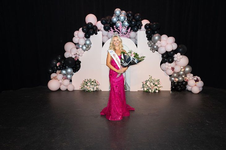 A woman in a pink dress is standing on a stage holding a bouquet of flowers.
Miss Huntington Beach, Nicole Allyson Vogt 2024-2025