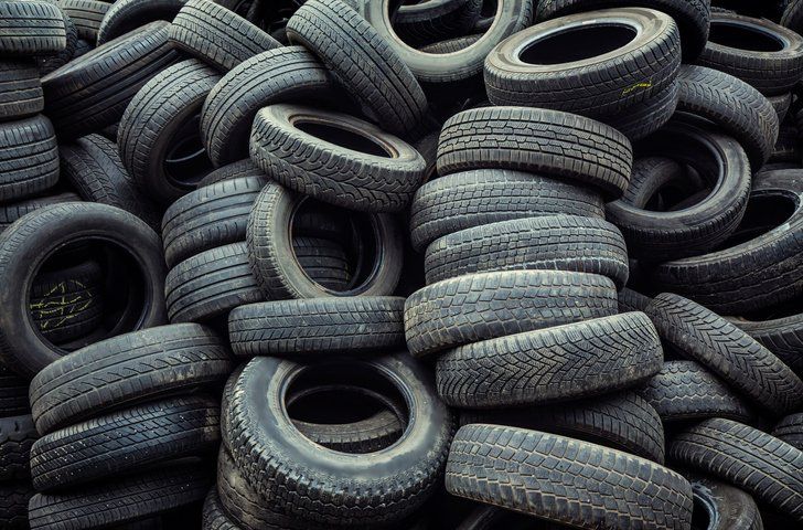 a pile of old tires stacked on top of each other .