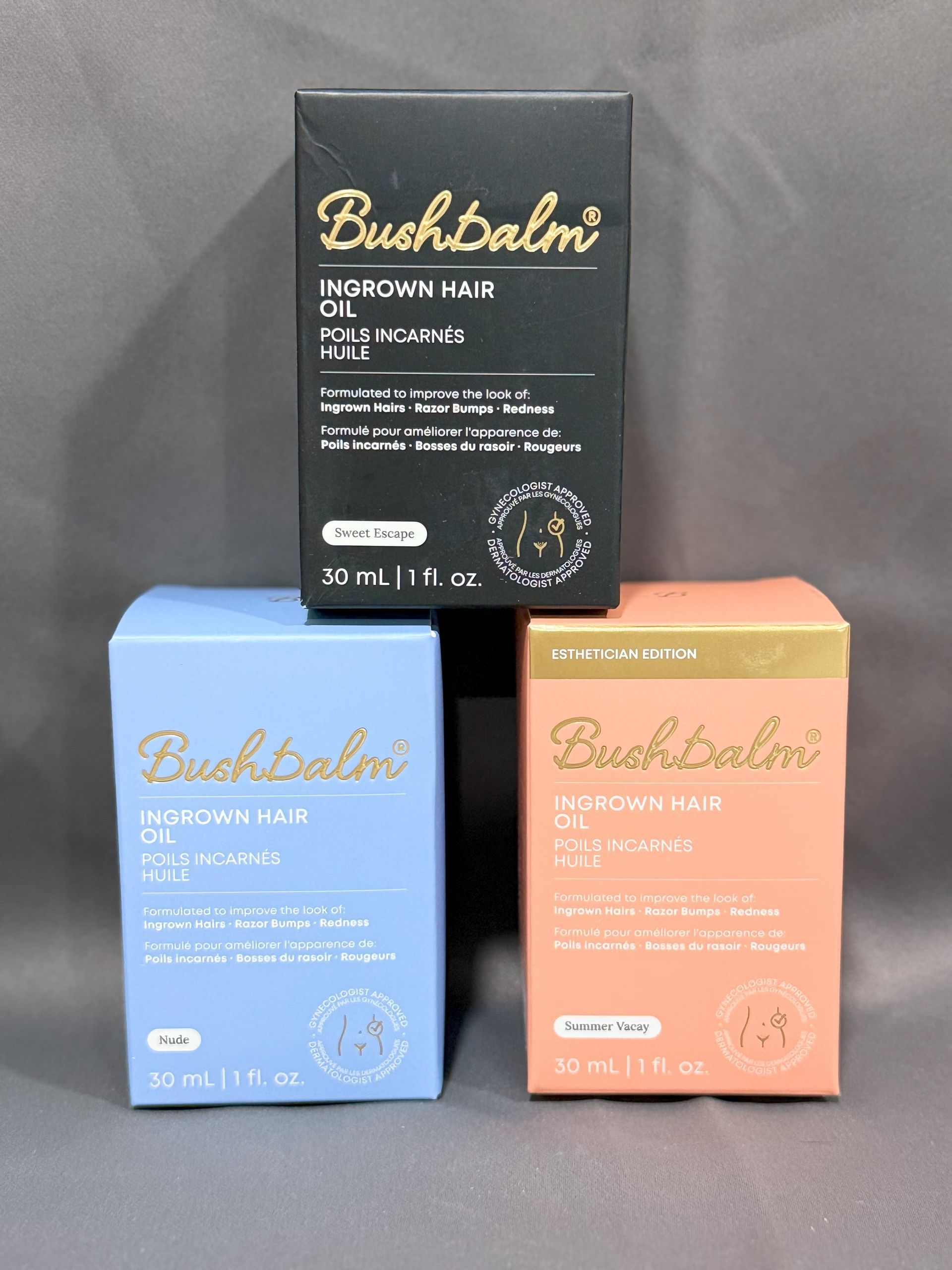 Three boxes of Bushbalm skincare products: indigo, light blue, and orange.