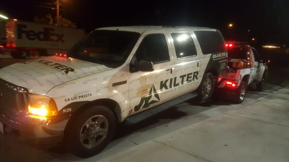 Tow truck towing a white SUV with 