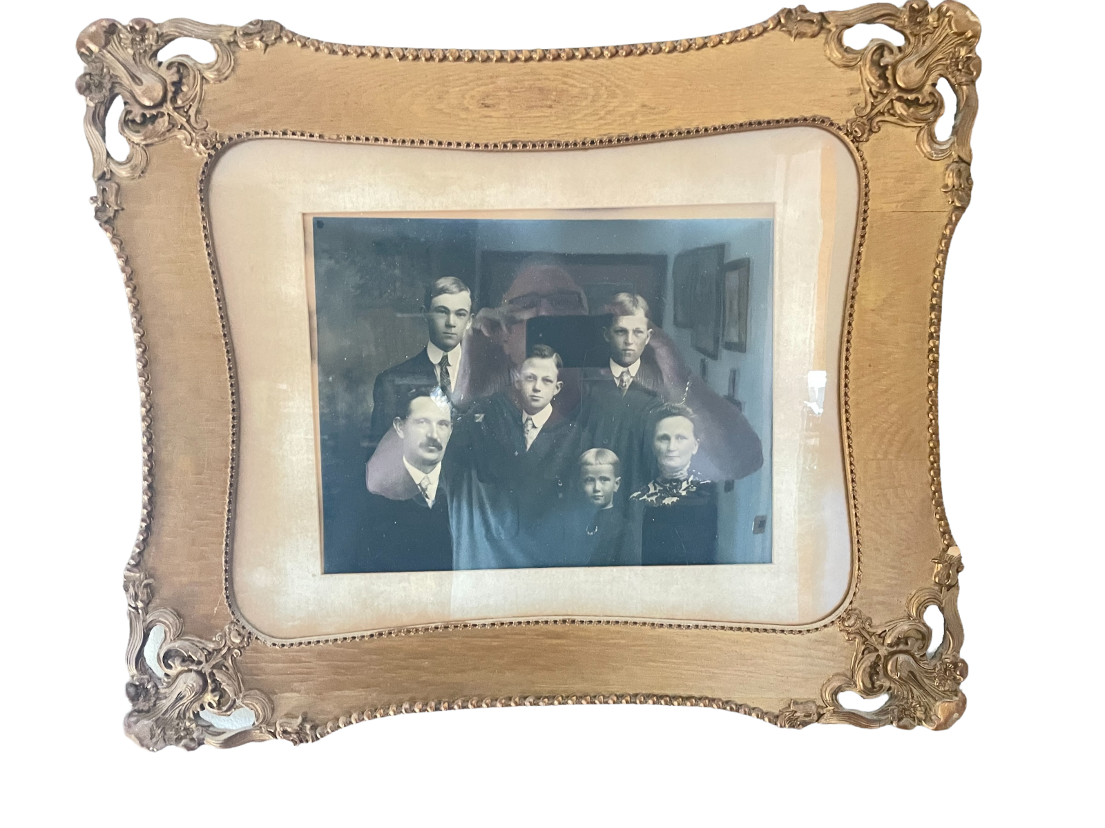 image of a vintage picture of a early 20th century family in a small, tan-colored ornate frame