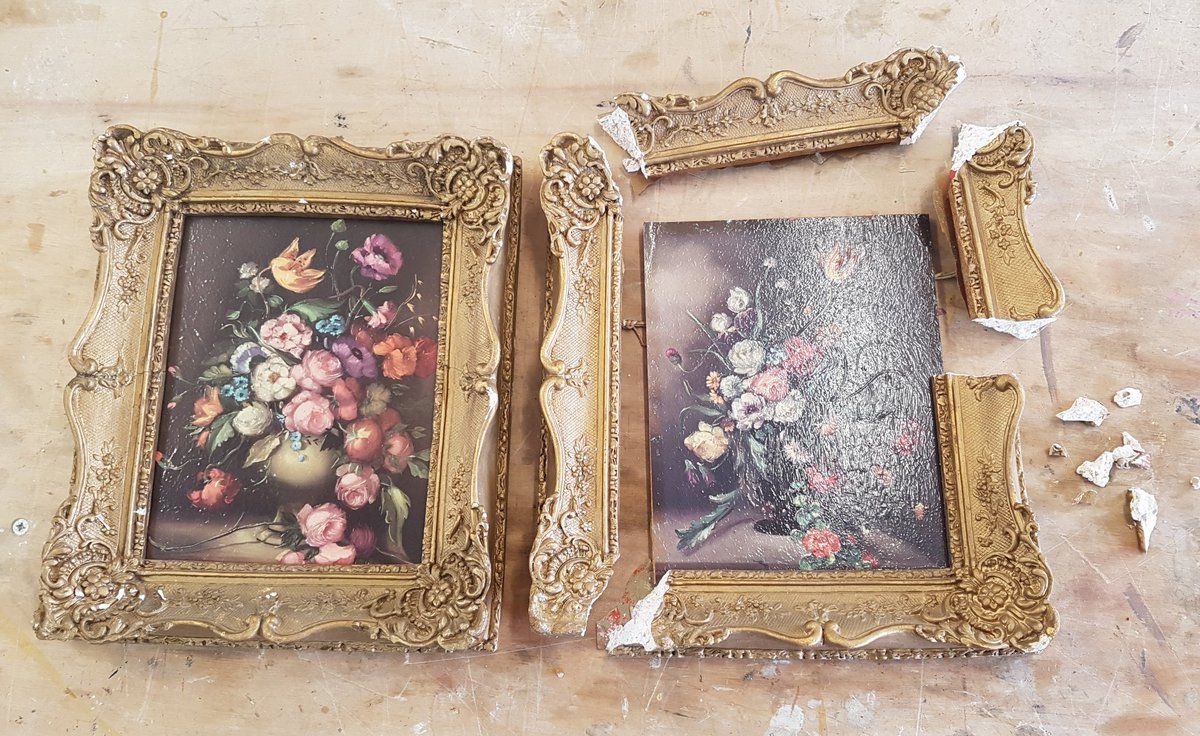 two framed paintings side by side.  The frame on the right is broken into pieces; the painting to the left is all intact.