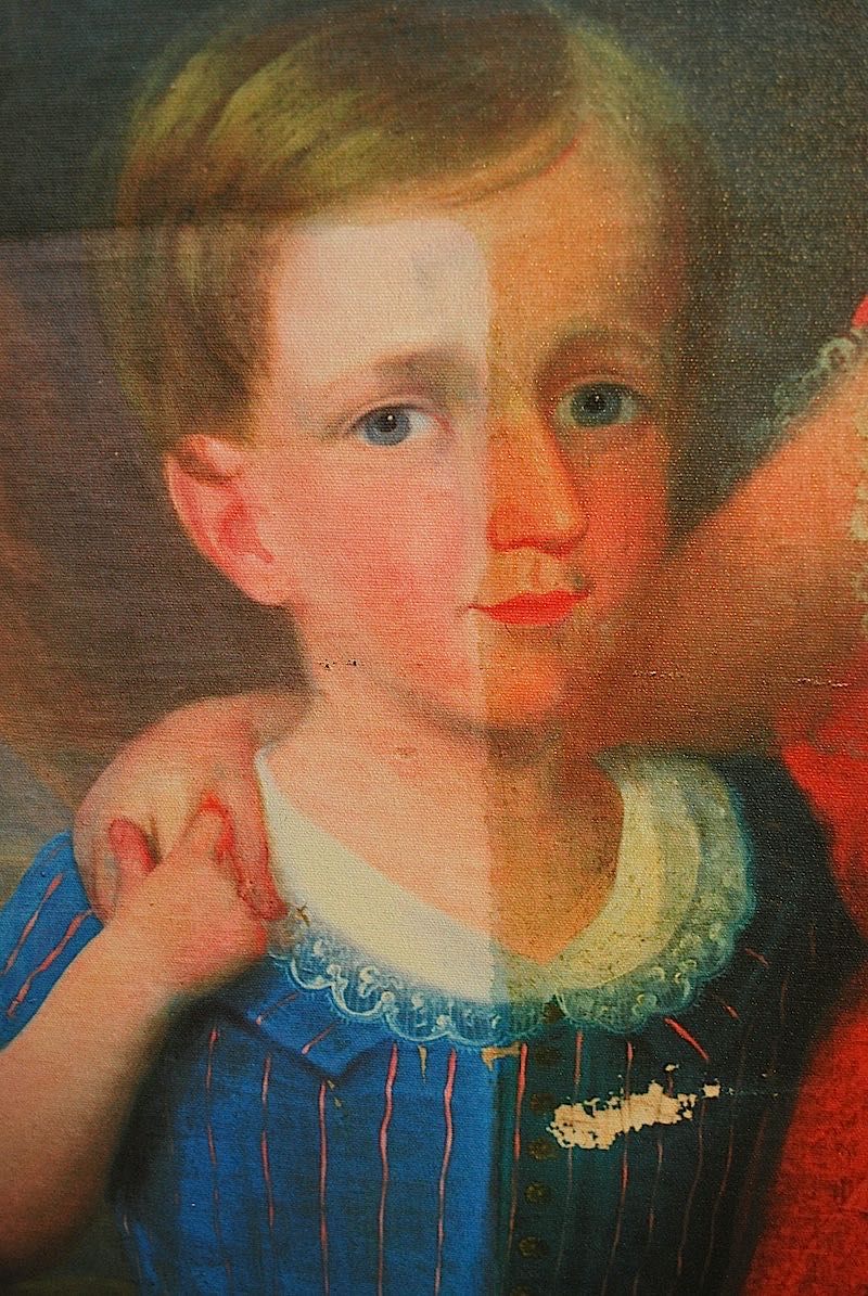 A painting of a young white boy in antiquated clothing that is clean on the left side and has dirty varnish on the right side