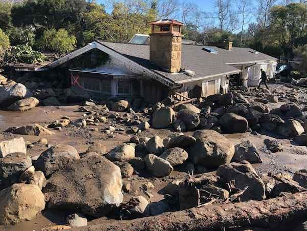 image of a house submerged in a rocky landslide