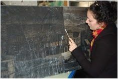 Art conservator, Virginia Panizzon, cleaning water damage on paintings