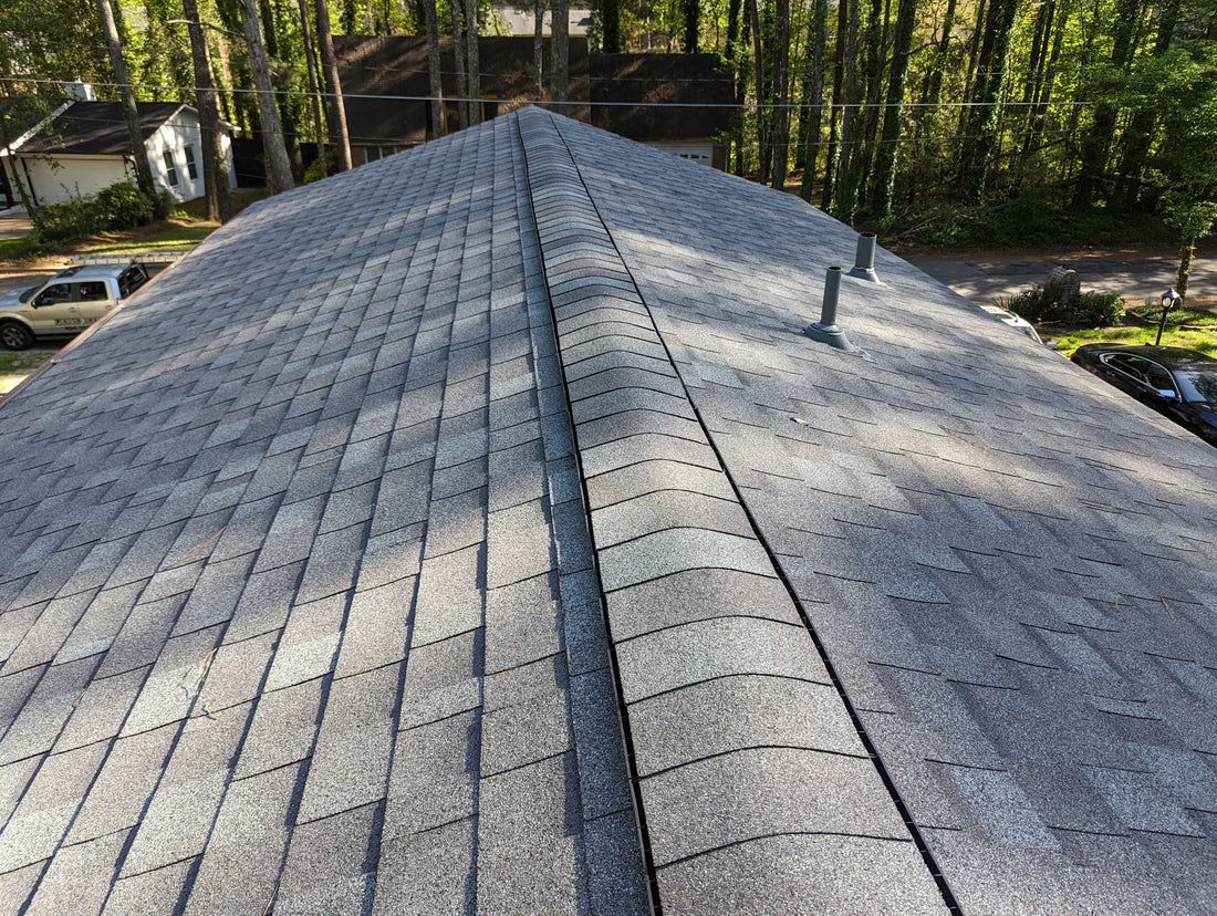 Gray asphalt shingle roof on a house, view from above.
