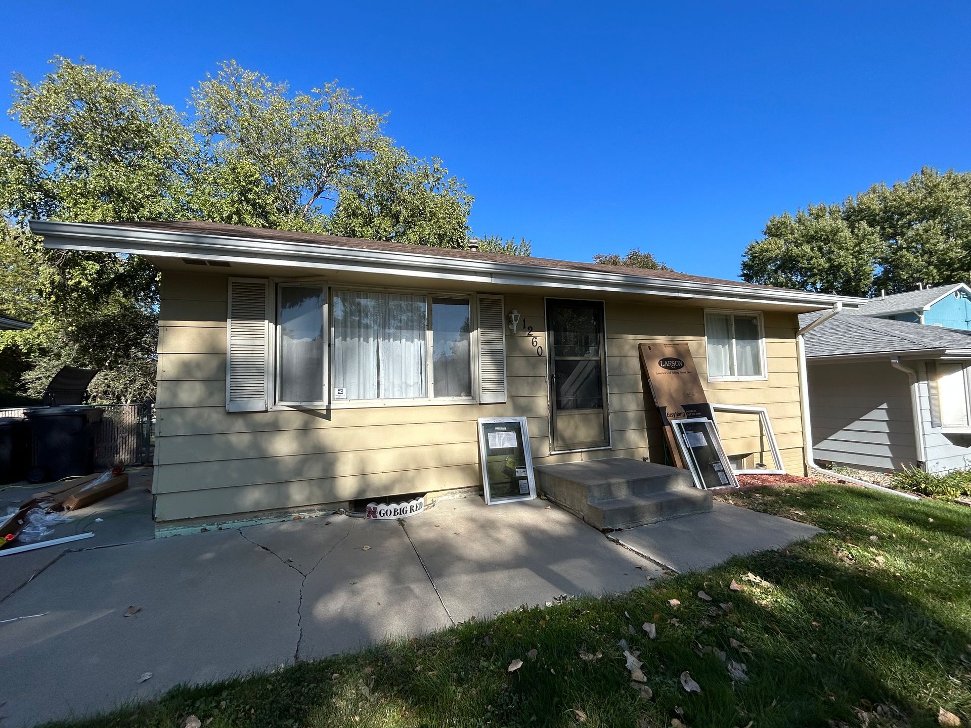A house is being painted with a blue sky in the background.