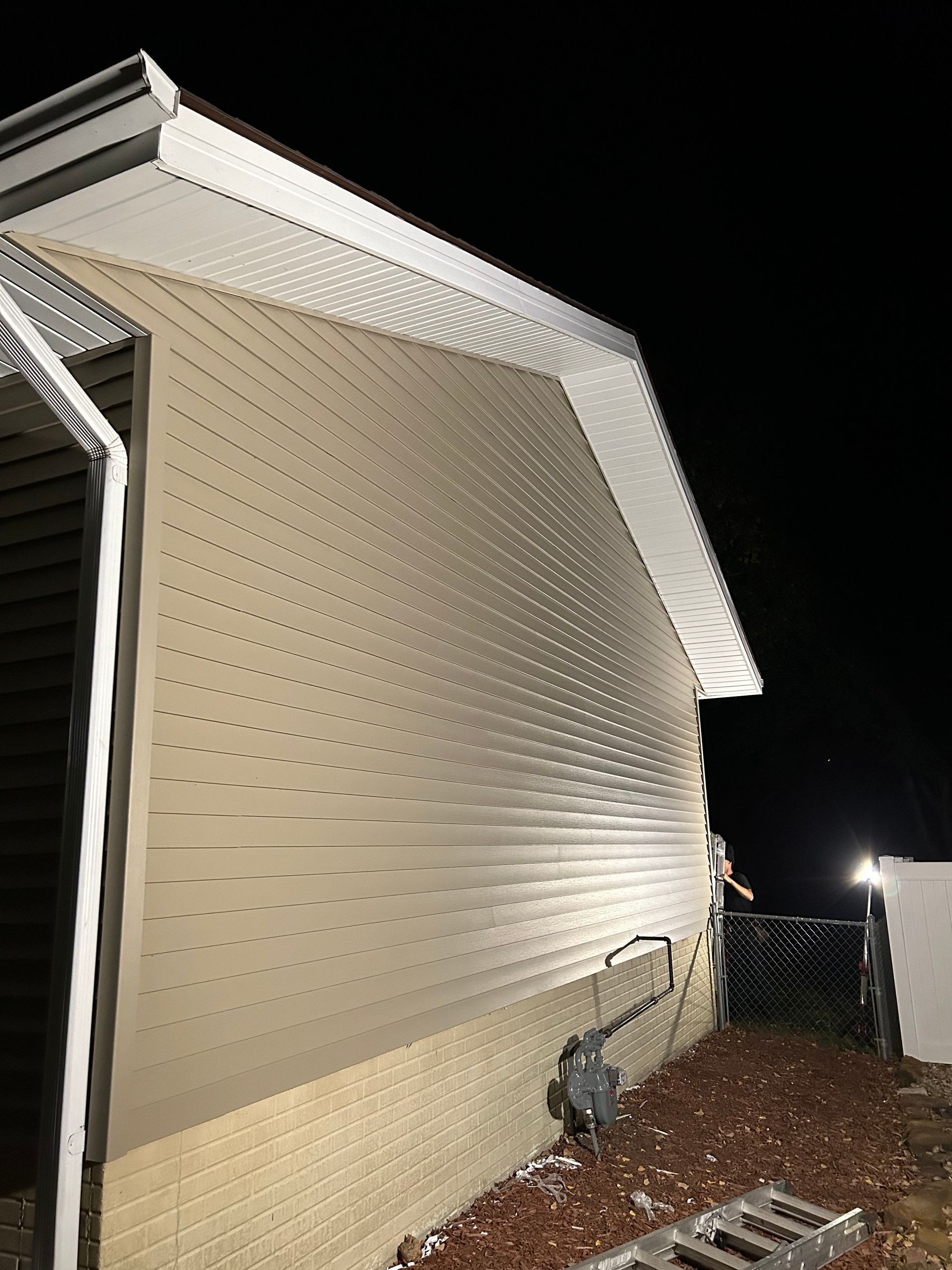 A mobile home is being remodeled at night.
