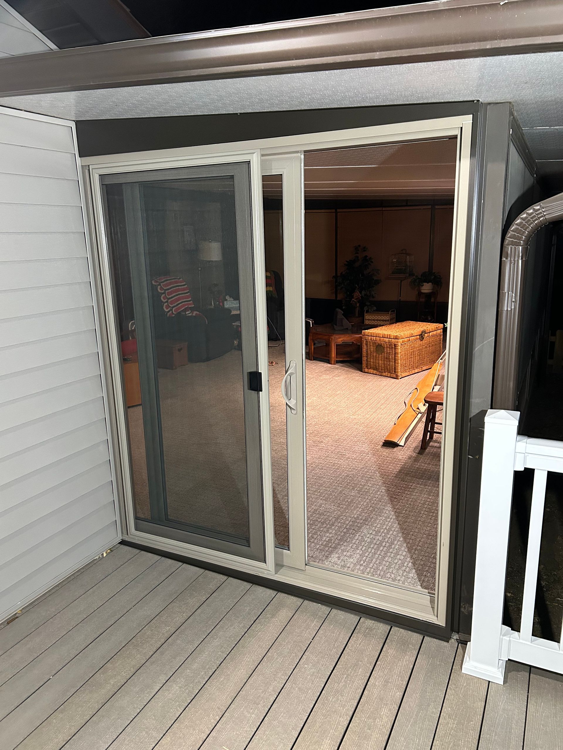A sliding glass door is open to a living room.