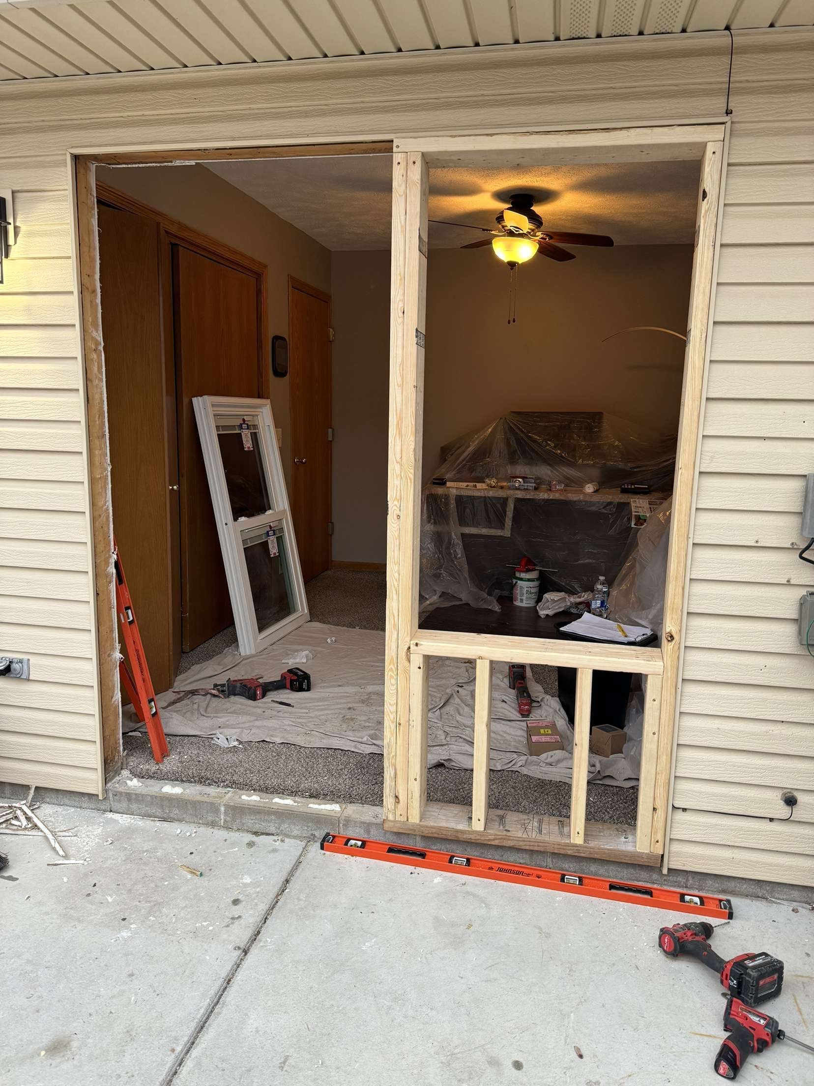 A sliding glass door is being built into a house