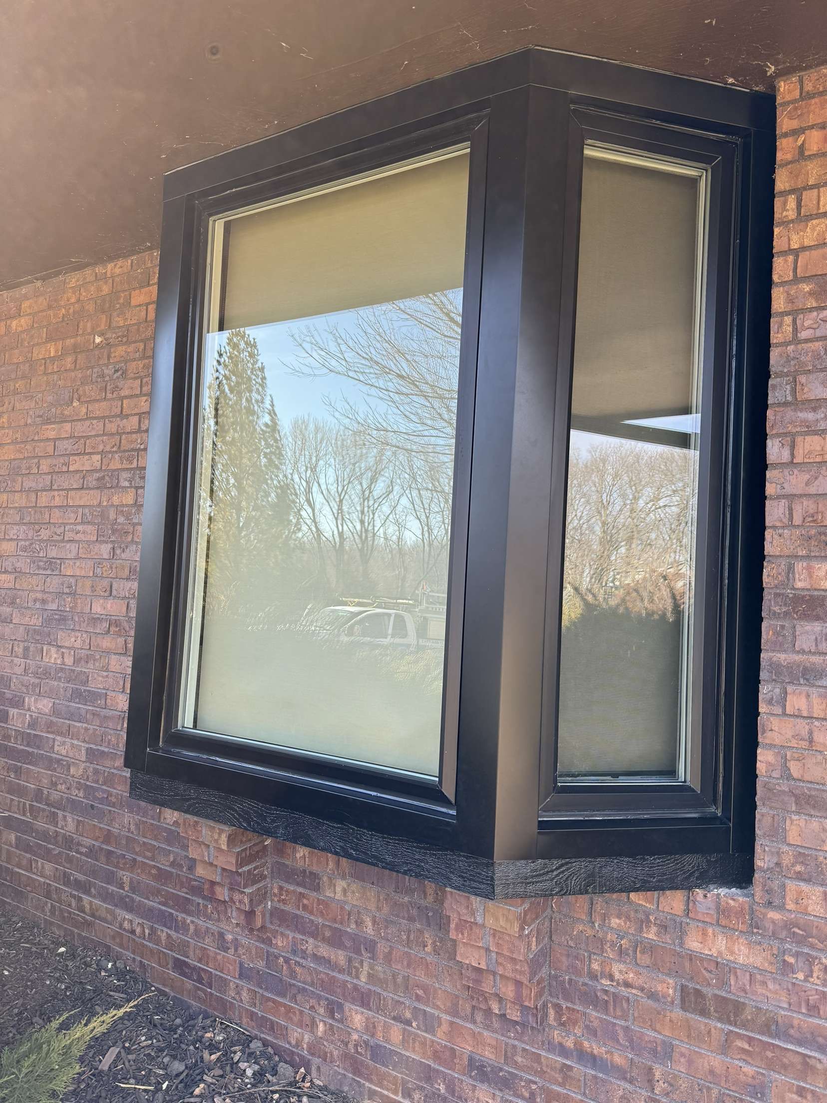 A large window on the side of a brick building.