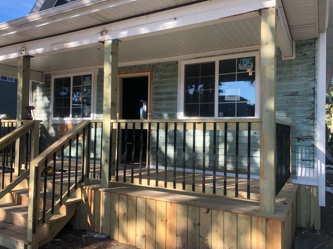 A house with a wooden porch and stairs.
