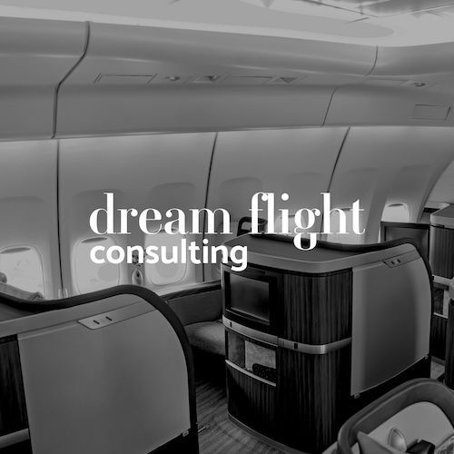 Black and white airplane cabin with lie flat seats and the text 