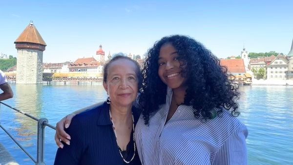 Jess and her grandmother stand together by Lake Lucerne with the Chapel Bridge and historic waterfront behind them. The family photo shows why Switzerland is worth visiting for both meaningful memories and classic Lucerne views.