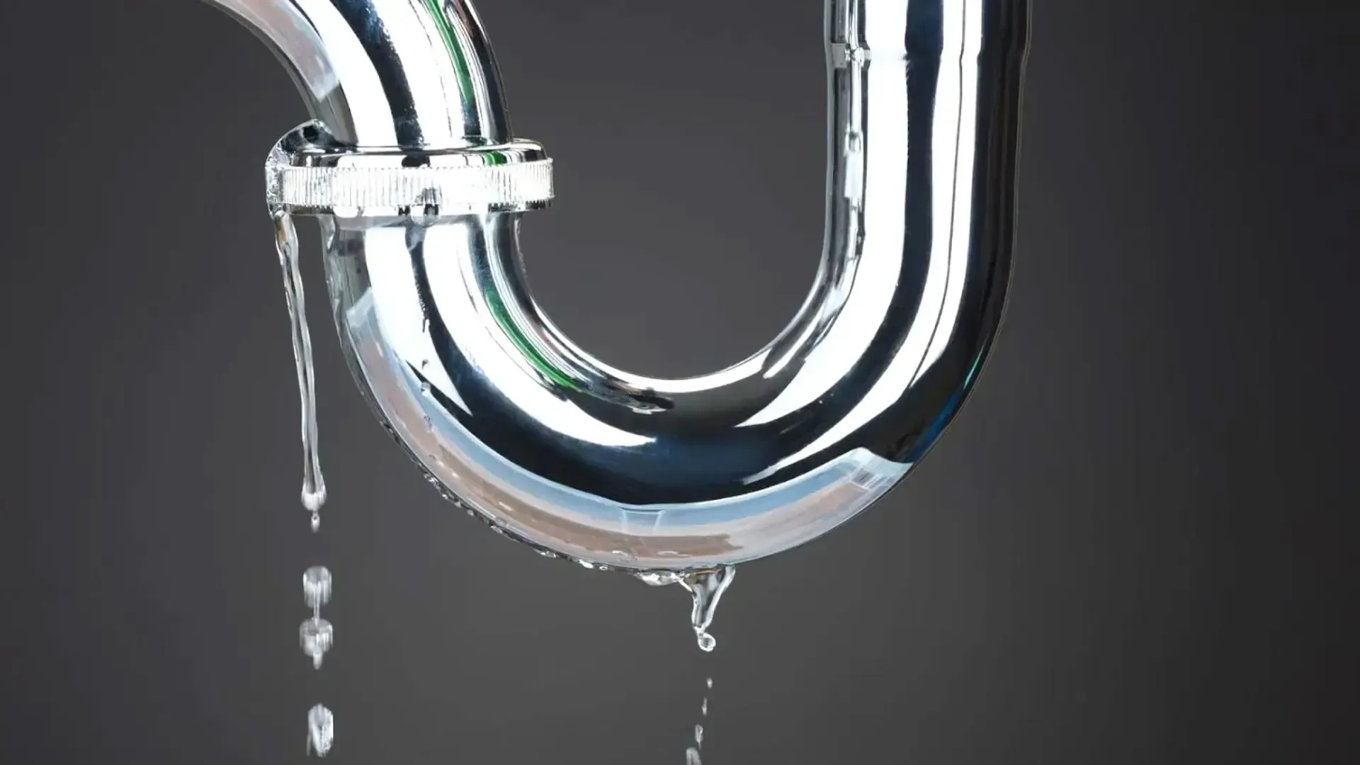 A close up of a drain pipe with water leaking out of it.