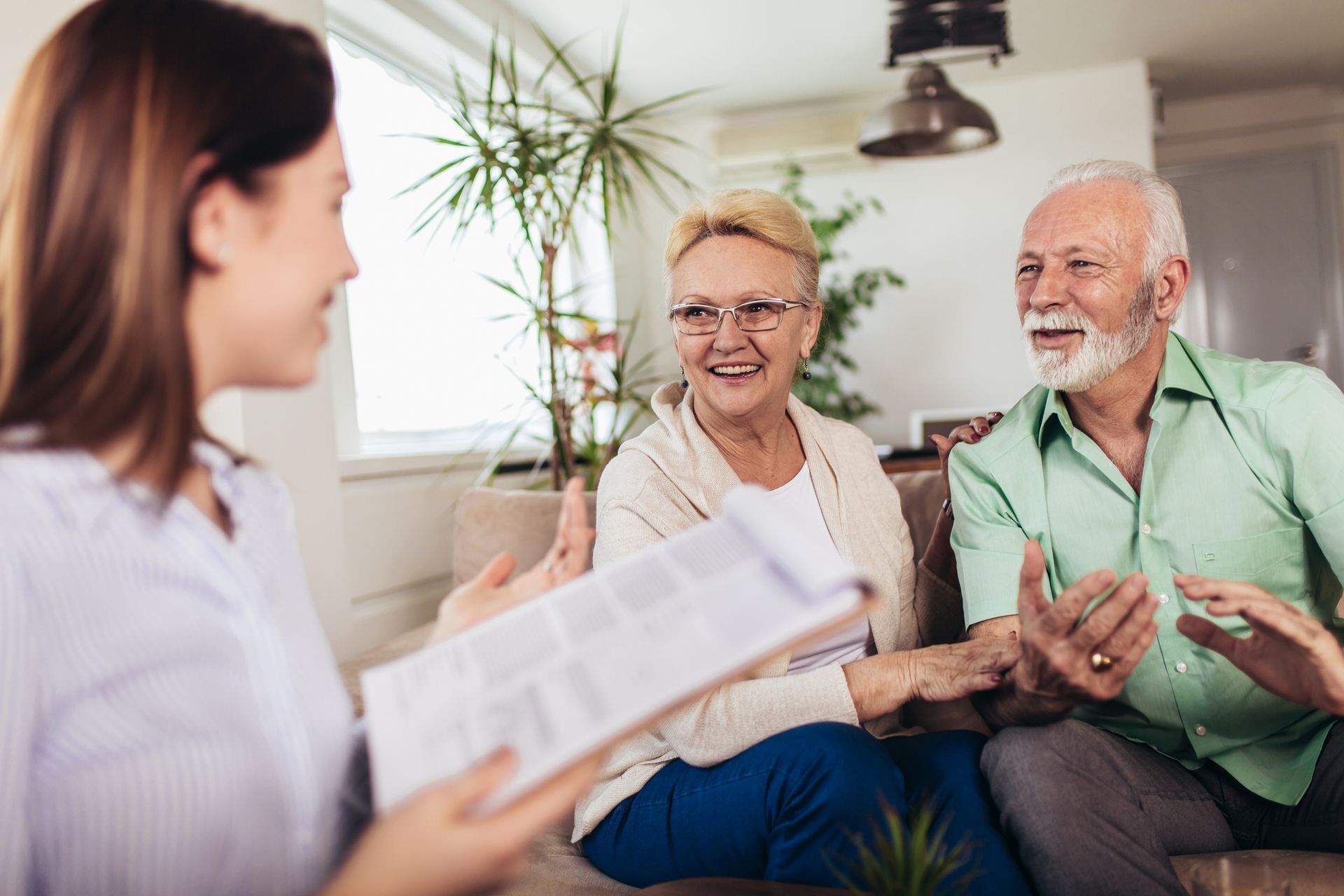An Elderly Couple Sitting On A Couch Talking To A Tax Adviser - Hobart, TAS - Stuart Iles Partners