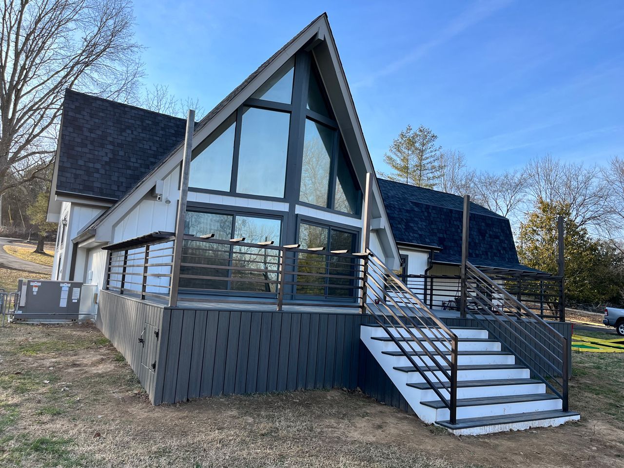 A house with a lot of windows and stairs on the side of it.