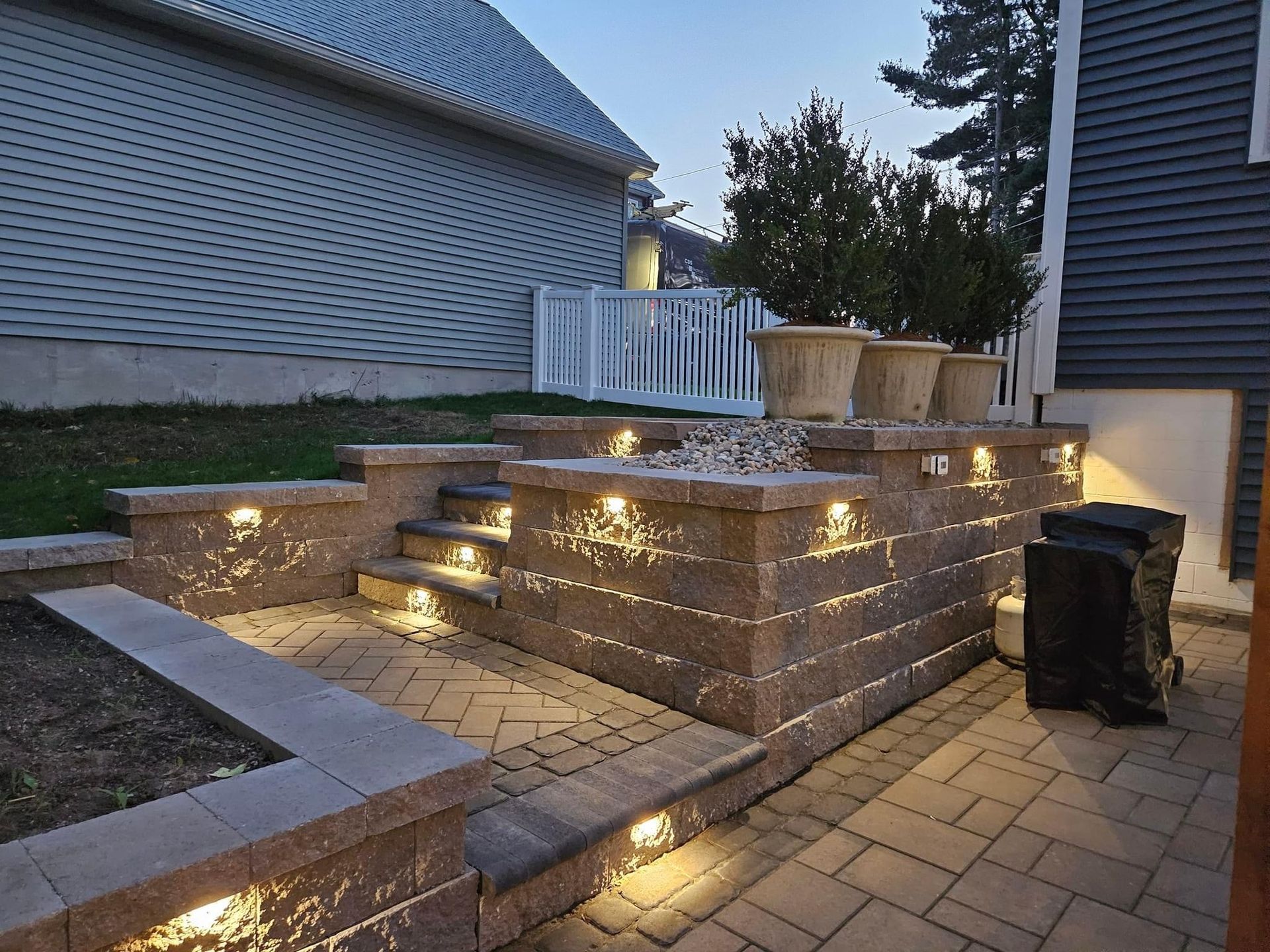 A brick walkway with stairs leading up to a house