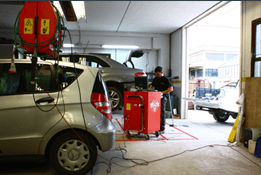 Un uomo sta lavorando su un'auto in un garage.