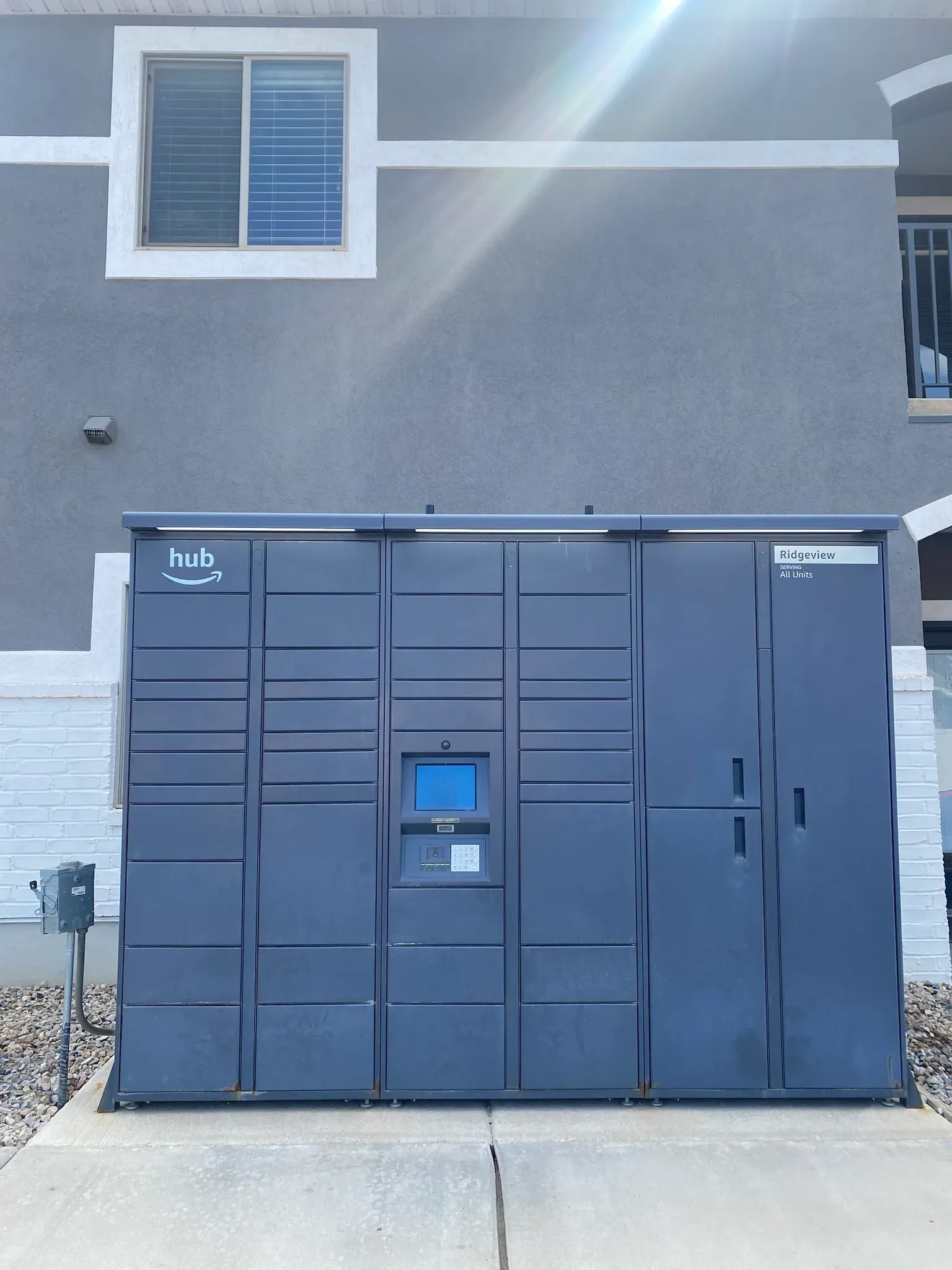 Amazon Hub package locker system outside apartment building.