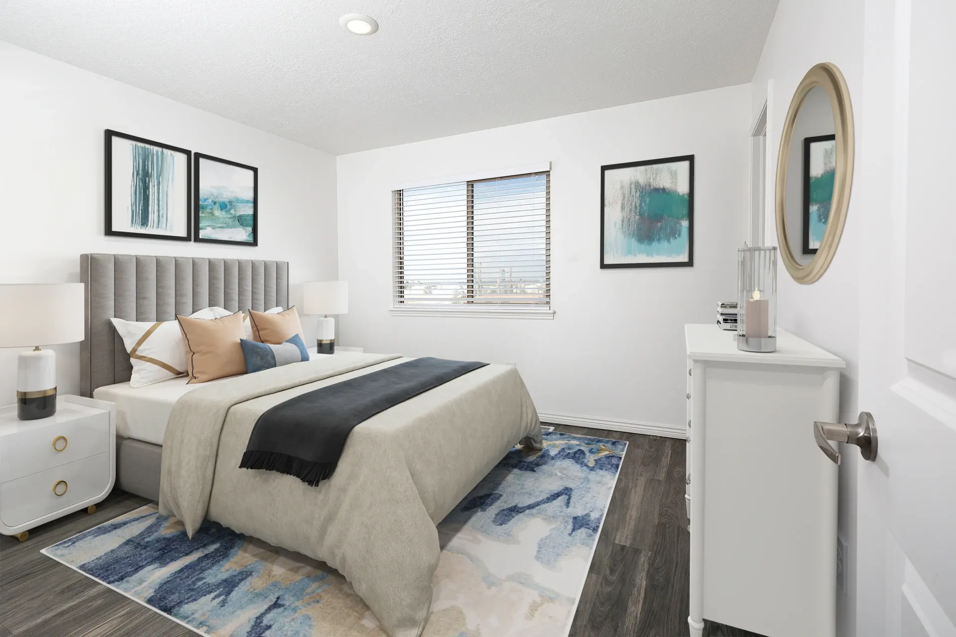 Bedroom with a queen-size bed, nightstands, dresser, and artwork.