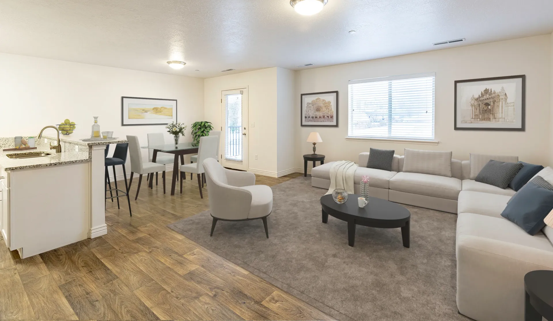 Spacious living room with a large sectional sofa and coffee table, adjacent to a dining area and kitchen.