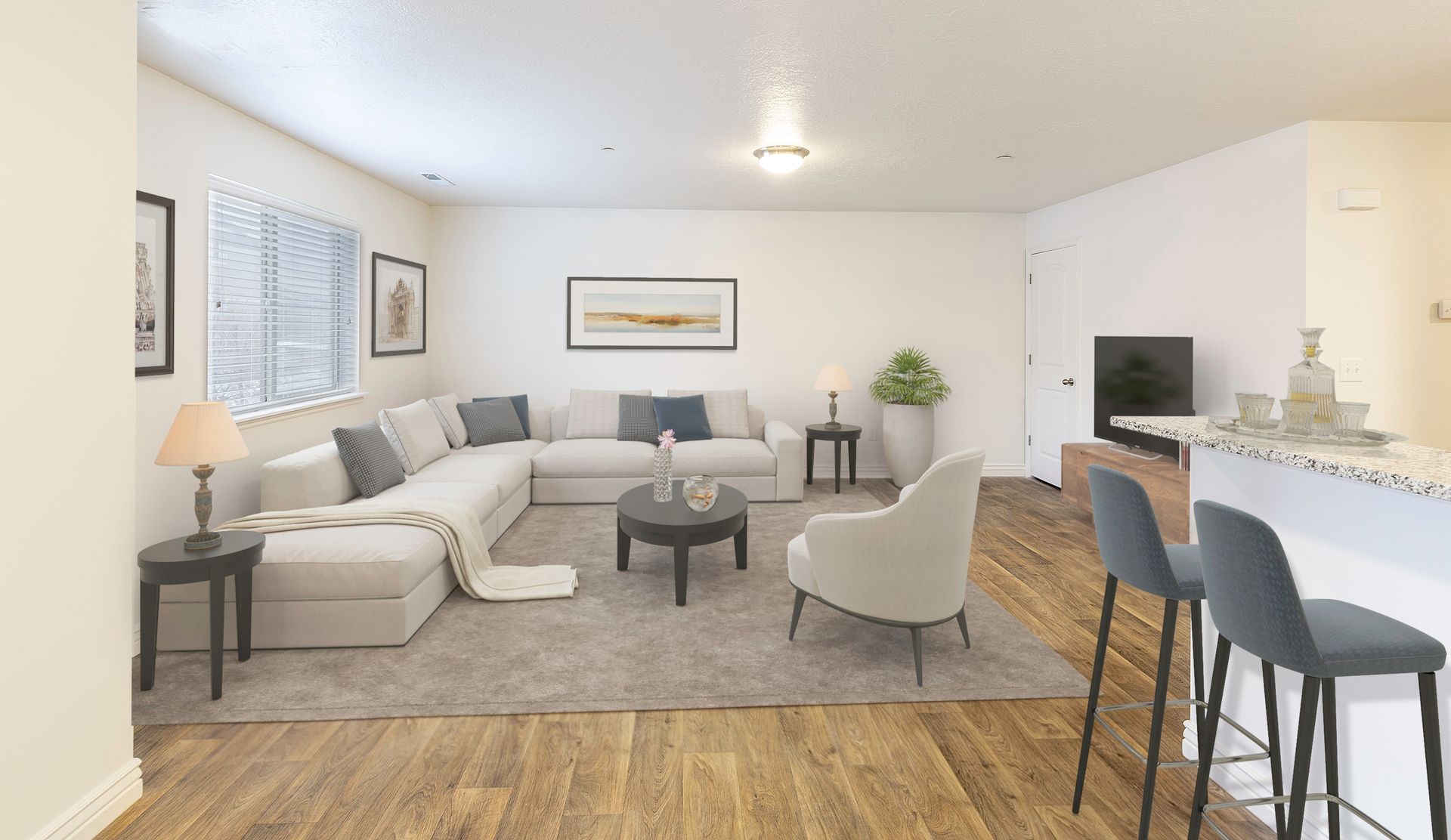 Spacious living room with a large sectional sofa, coffee table, and bar seating.