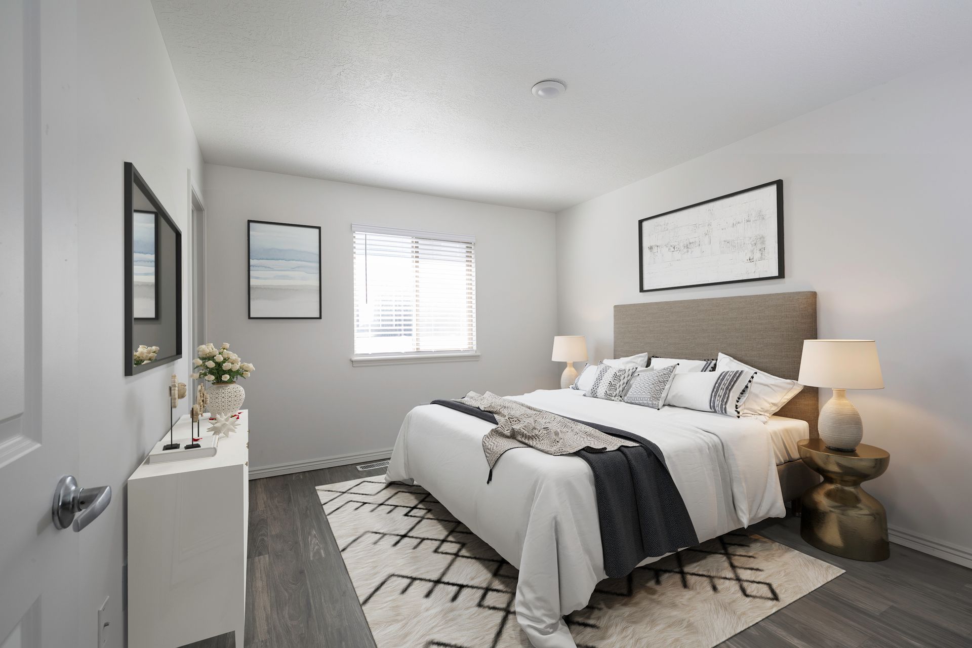 A bedroom with a queen-sized bed, dresser, and two nightstands.