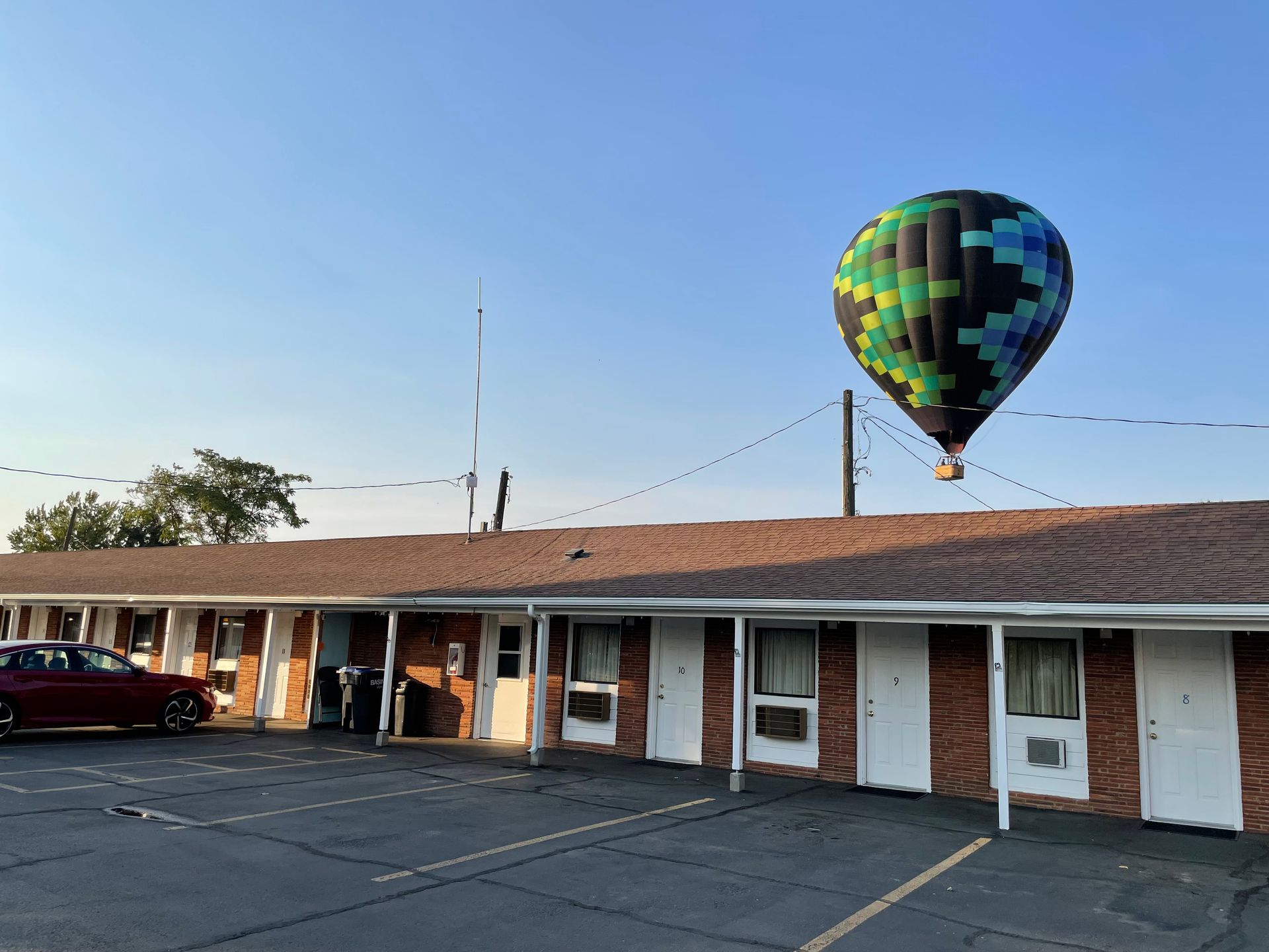 A hot air balloon is flying over a motel