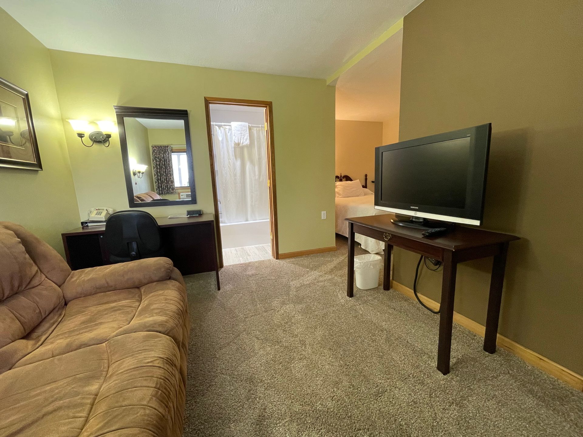 A living room with a couch and a flat screen tv.