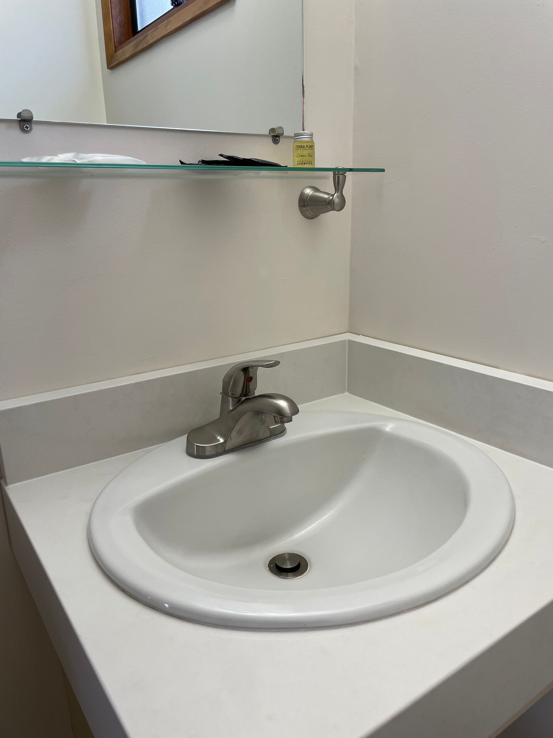 A bathroom sink with a mirror above it