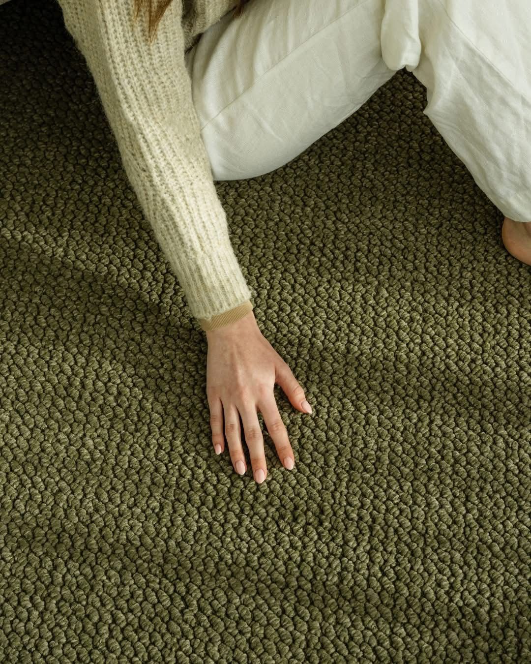 A Living Room with A Couch, Coffee Table and Fireworks on The Wall — Kelwin Coastal Carpets In Kundra Park, QLD