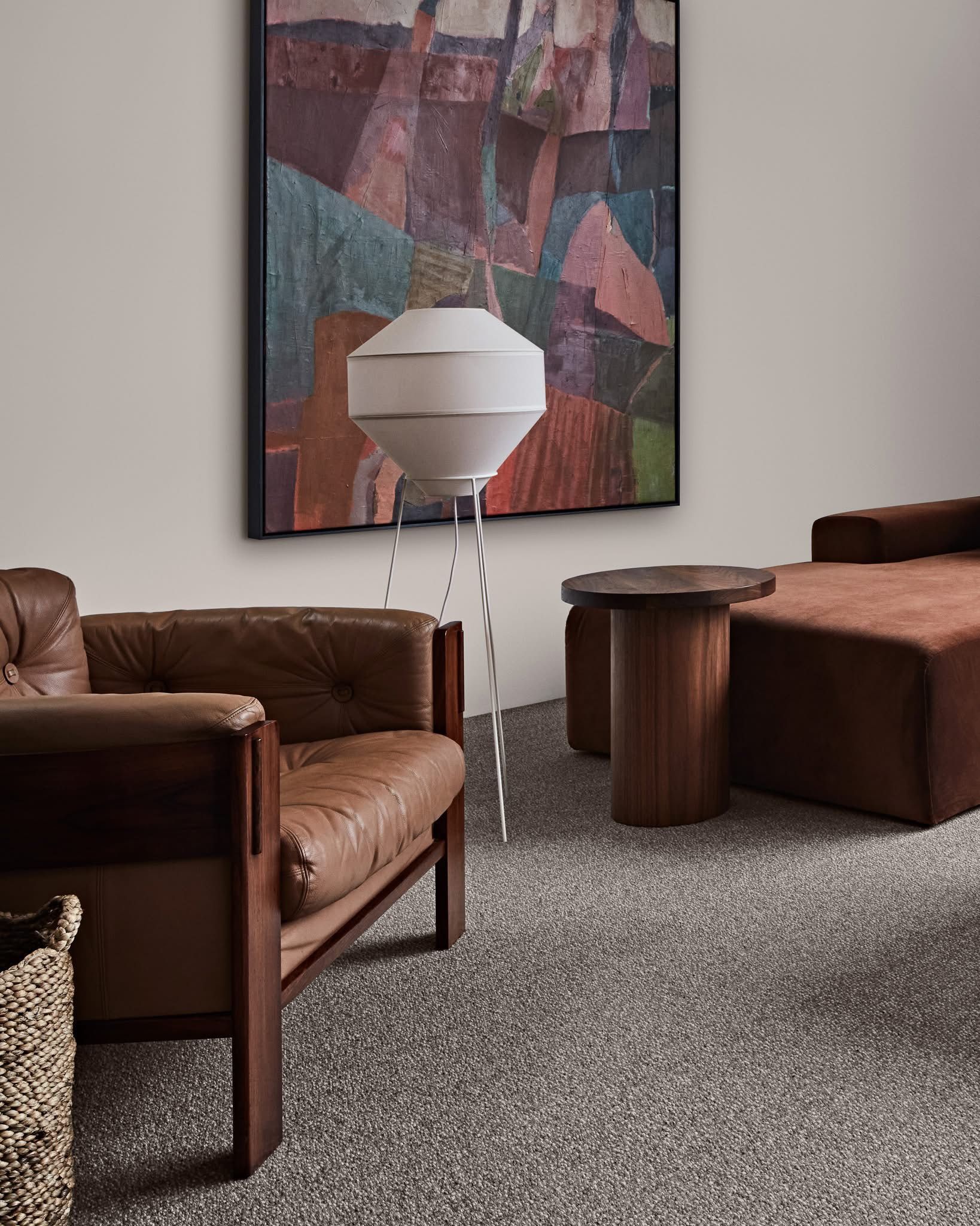 A Living Room with A Couch, Coffee Table and Fireworks on The Wall — Kelwin Coastal Carpets In Gympie, QLD