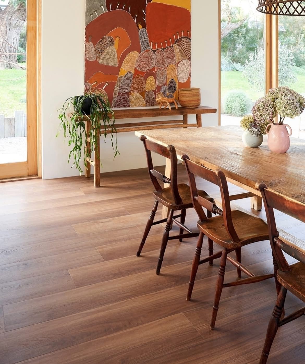 A Kitchen with White Cabinets, Wooden Floors and Stools — Kelwin Coastal Carpets In Kundra Park, QLD