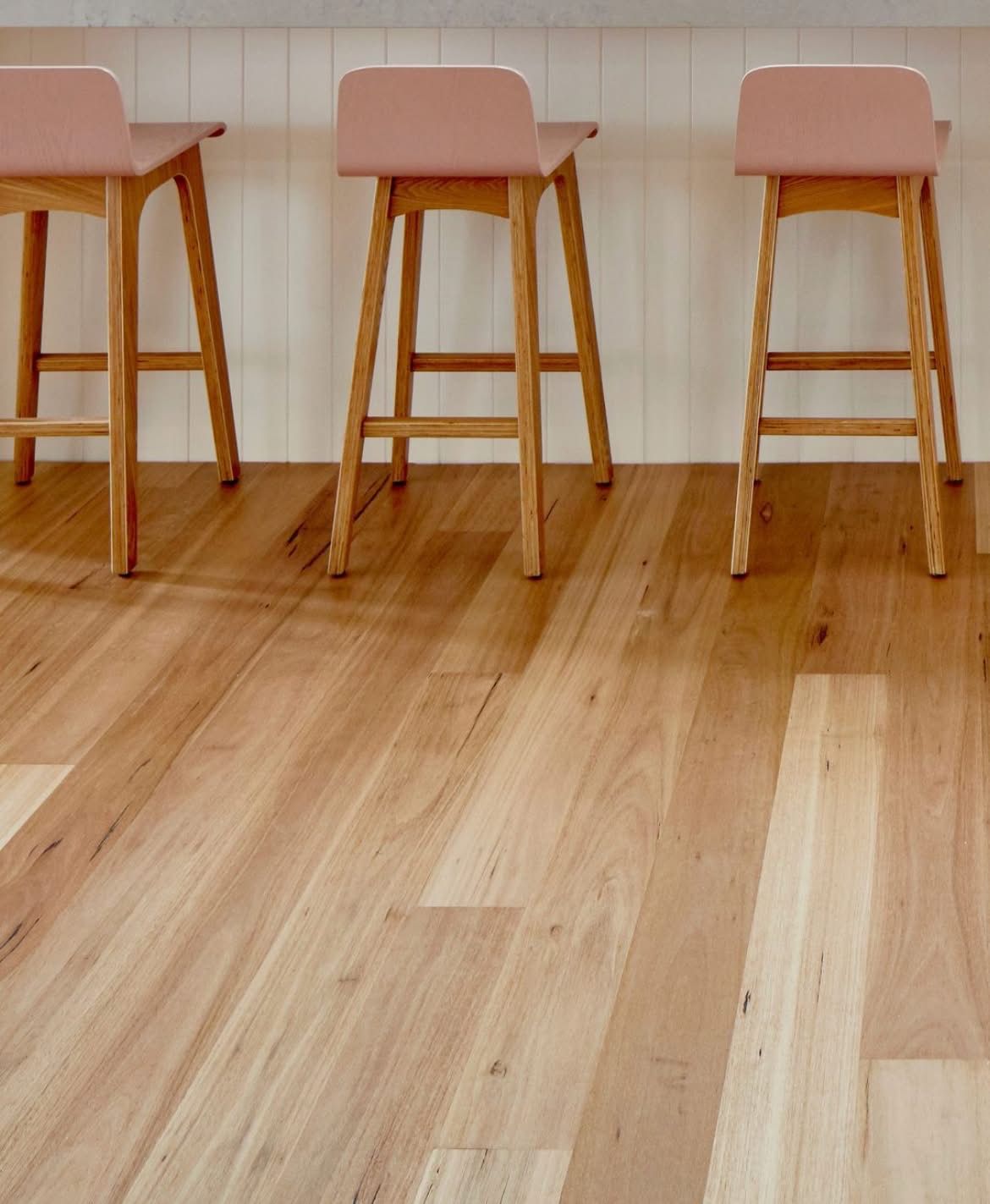 Restaurant interior: tables, bar stools, tropical decor, and large windows with natural light — Kelwin Coastal Carpets In Kundra Park, QLD