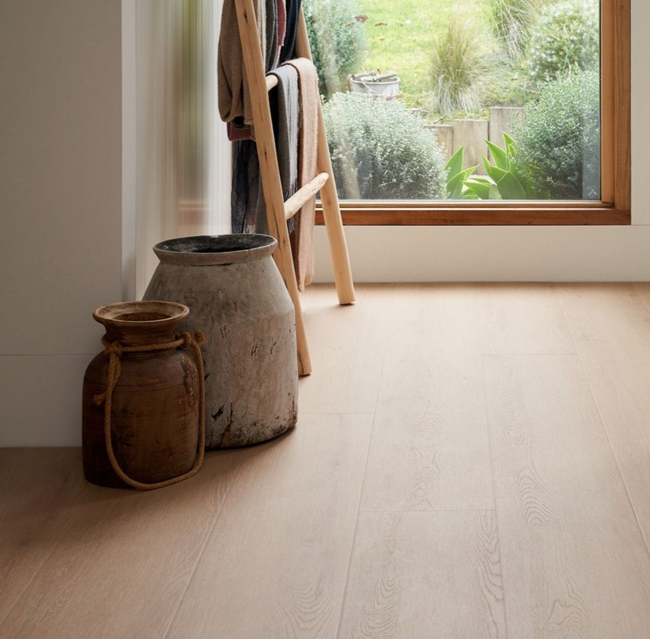 Dining room with wooden floor, table, chairs, and art on the wall — Kelwin Coastal Carpets In Kundra Park, QLD