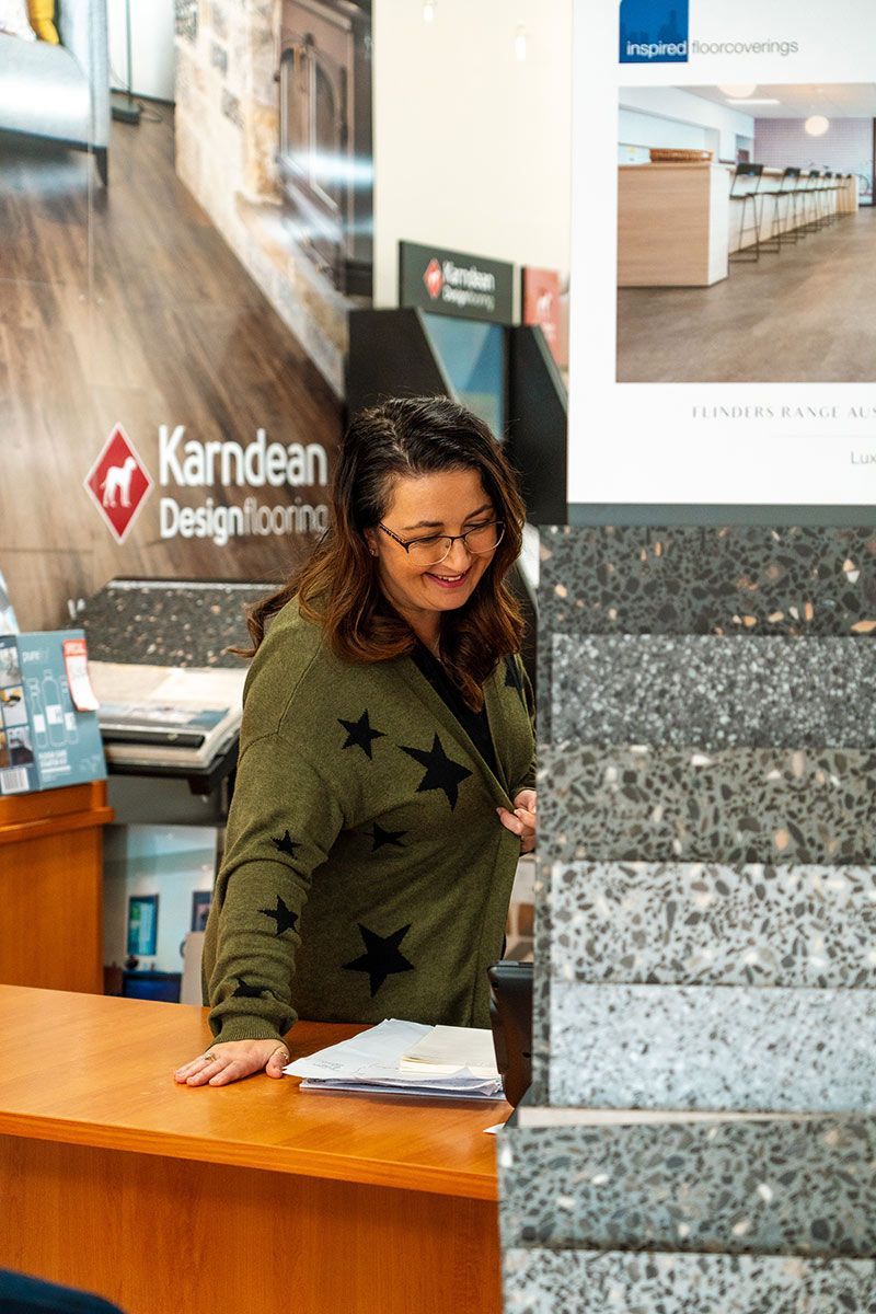A Kitchen with White Cabinets, Wooden Floors, and Stools — Kelwin Coastal Carpets In Kundra Park, QLD