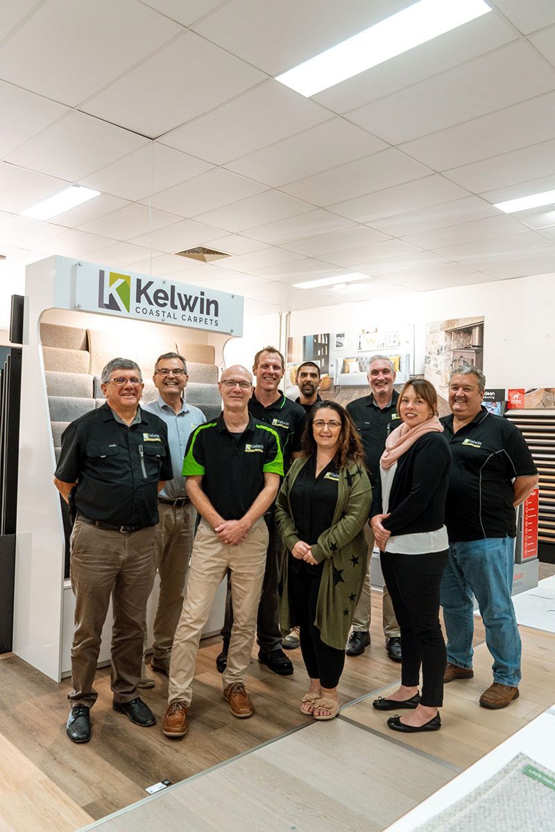 A Living Room with A Couch, Coffee Table, and Fireworks on The Wall — Kelwin Coastal Carpets In Kundra Park, QLD