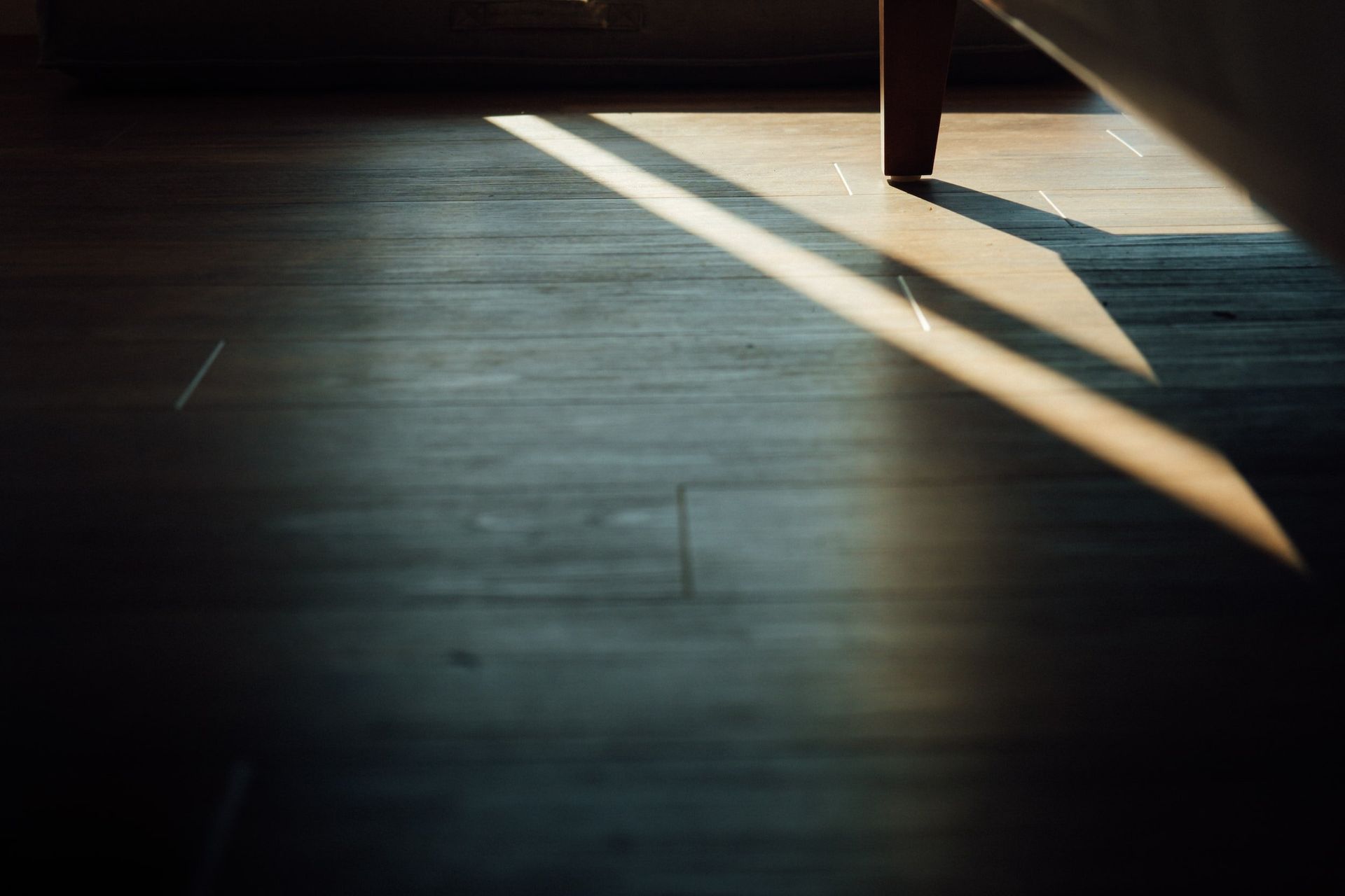 A Shadow of A Person Is Cast on A Wooden Floor — Kelwin Coastal Carpets In Kundra Park, QLD